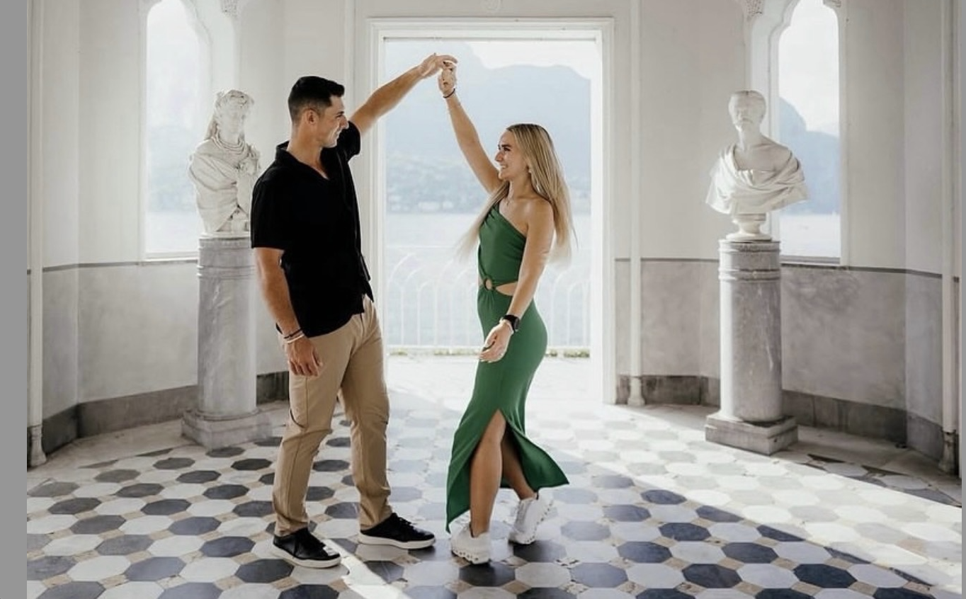 Couple dancing in marble pavilion with sea view
