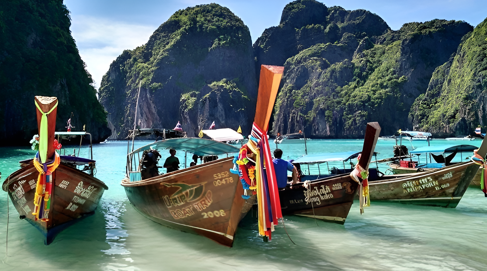 Colorful Thai longtail boats in turquoise water