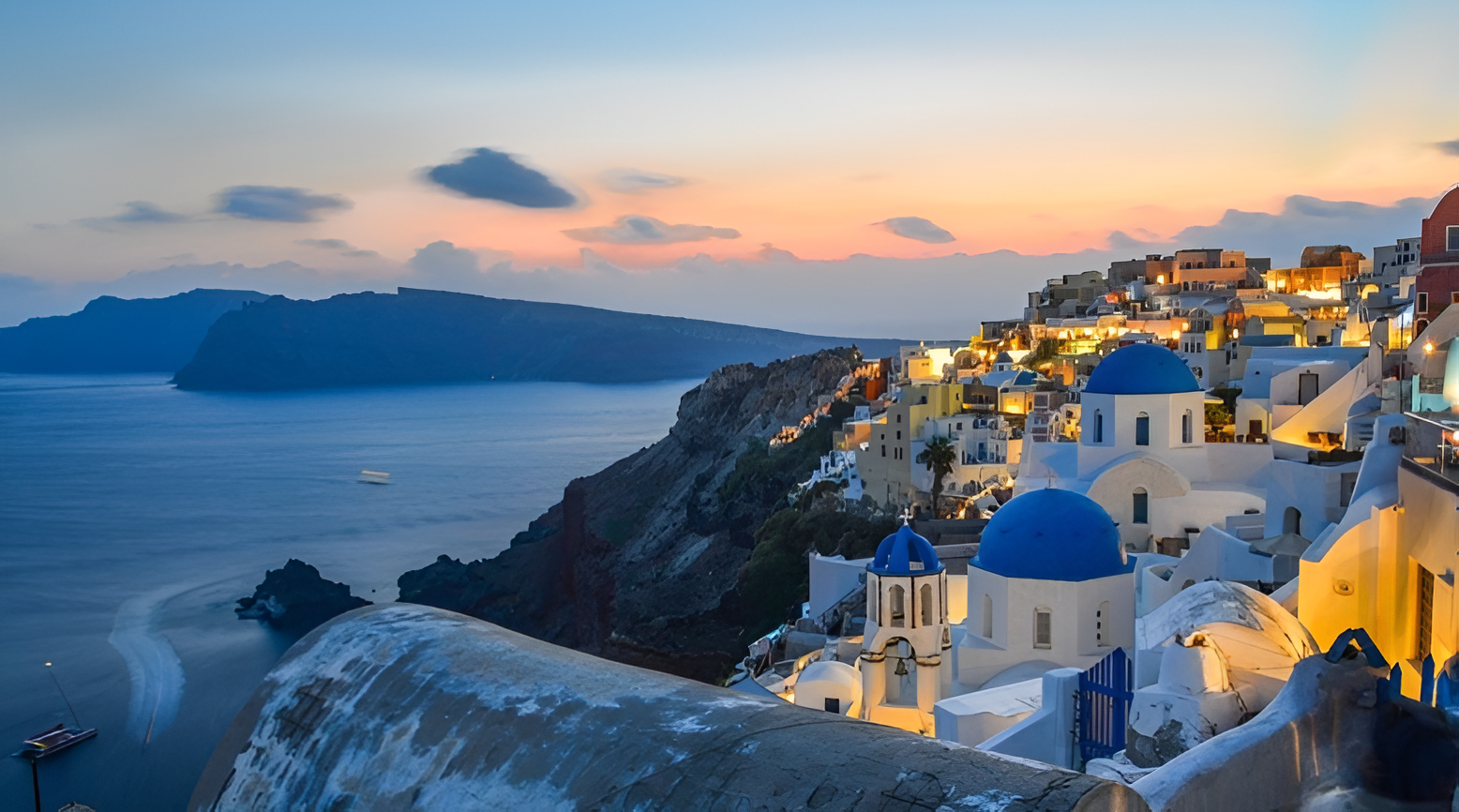 Santorini sunset with white buildings and blue domes